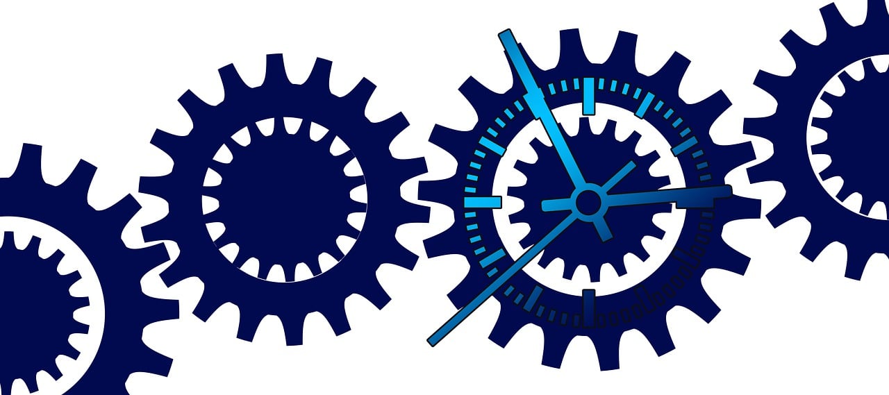 Illustration of interconnected blue gears, with one gear designed as a clock face showing time, symbolizing process integration, efficiency, and synchronization.